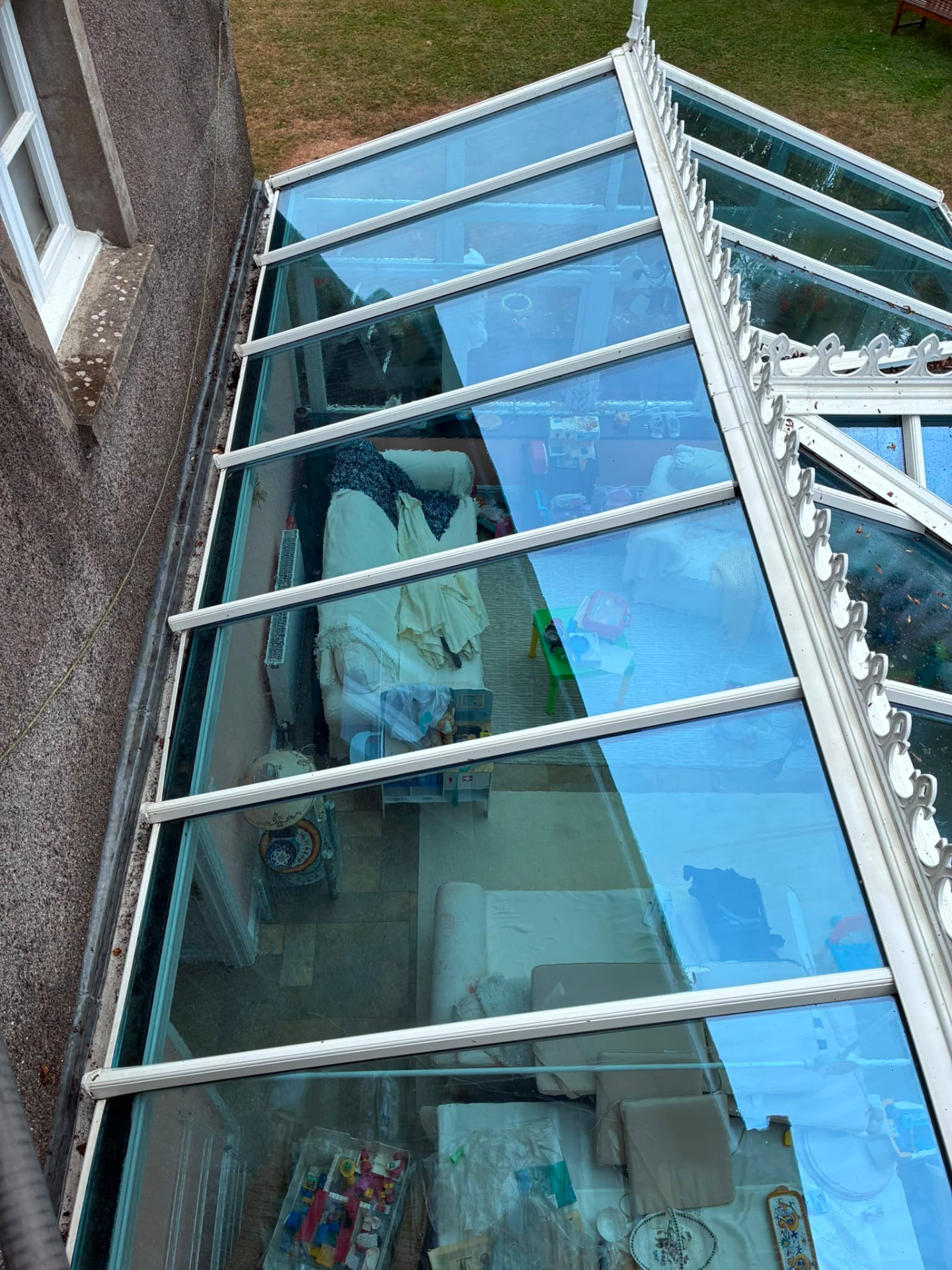 Conservatory glass roof before cleaning, dulled with dirt and algae