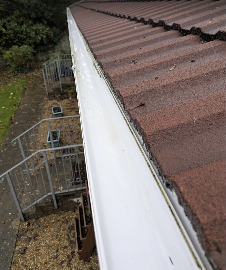 Freshly cleared gutter line ready for winter rain