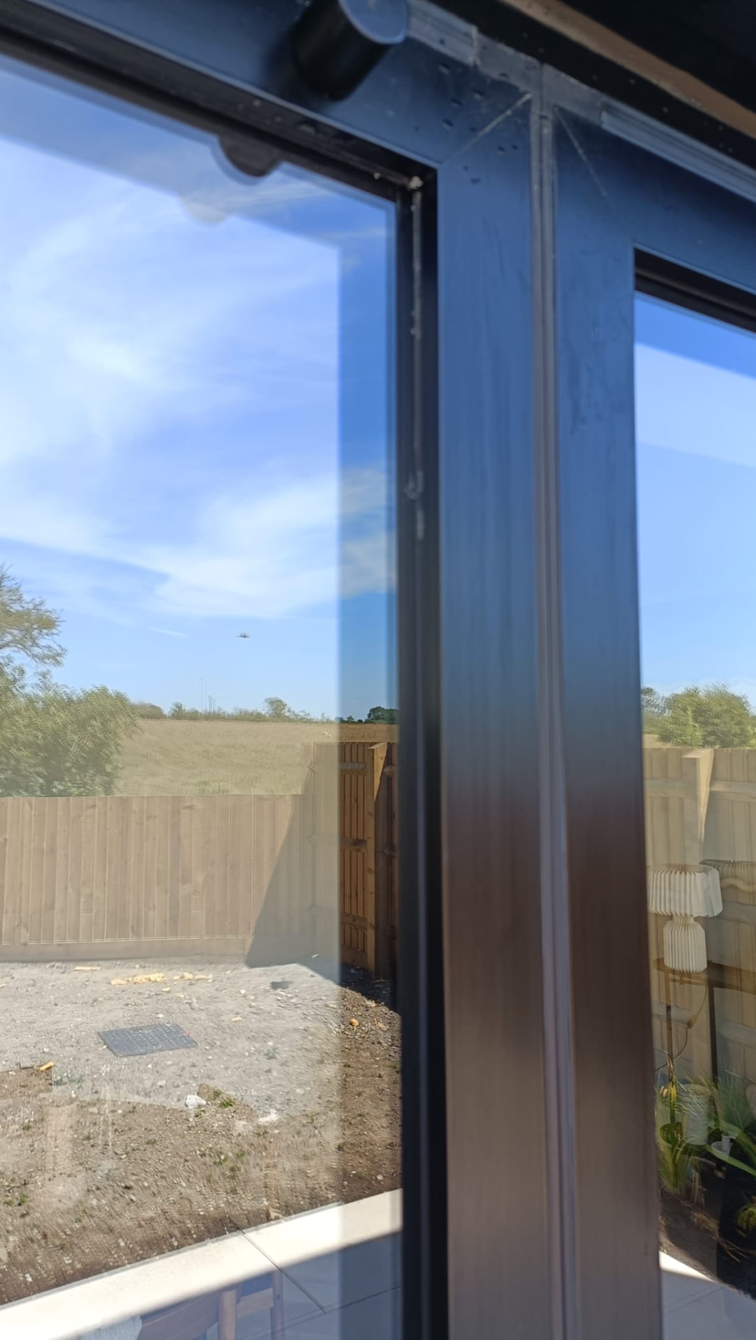 After: the same window cleaned to crystal-clear glass and spotless frames